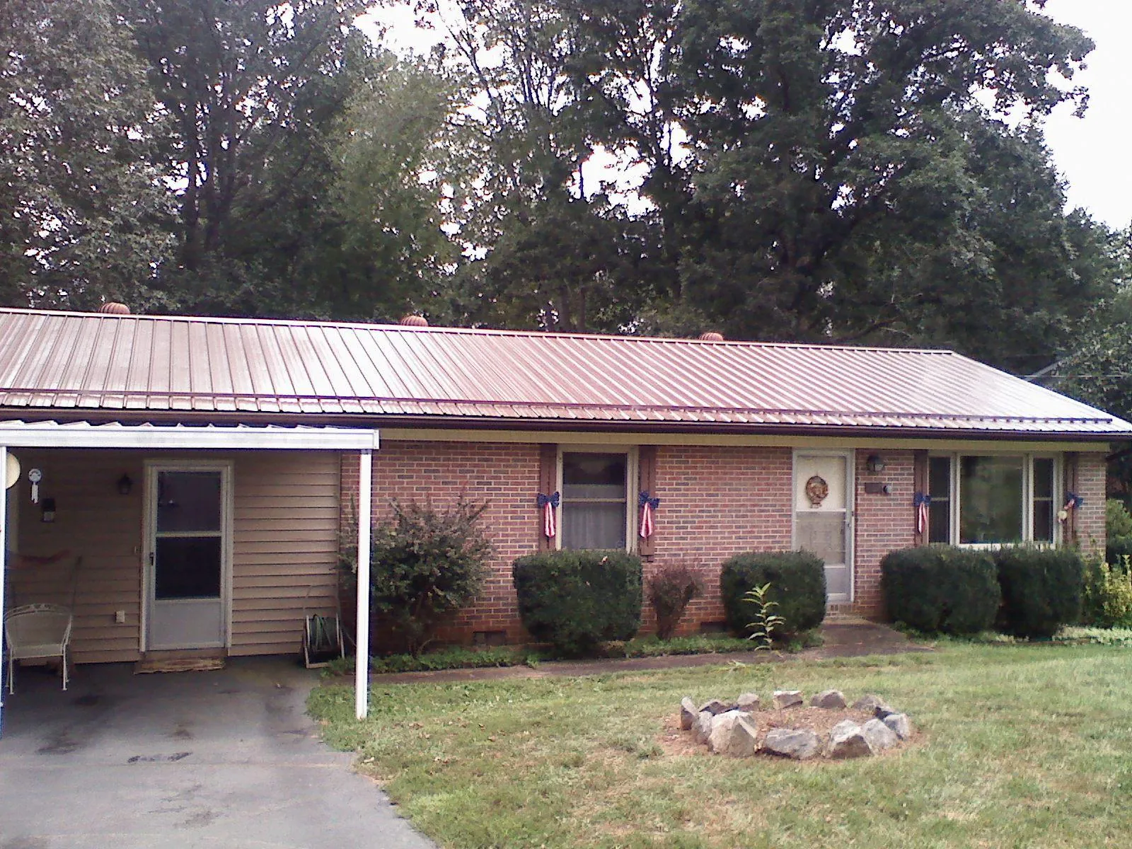 Bronze metal roof and carport on a brick ranch home — Roof Repair work by our crew in Weaverville